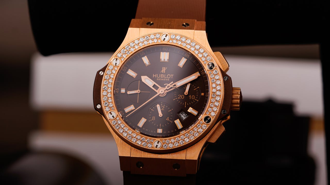 Close-up view of a luxurious gold watch adorned with diamonds, symbolizing elegance.